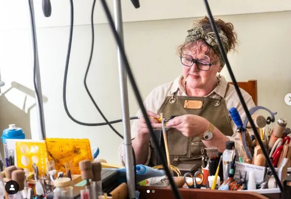 Storm working at her bench, surrounded by tools