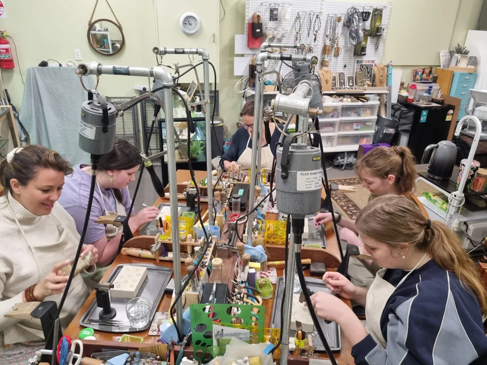 A class in progress at Gilded Poppy Makery, students working at the benches